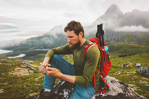 Man hiker using smartphone applicati featuring vacations, working, and remote