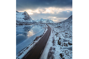 Aerial view of winter road at sunset, a Nature Photo by den-belitsky