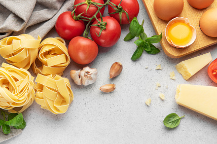 Fresh pasta, tomatoes, garlic, cheese, eggs and basil creating i, a Food & Drink Photo by Olena Rudo