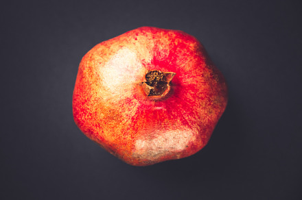 Pomegranate isolated on black background, a Food & Drink Photo by GoodGoods