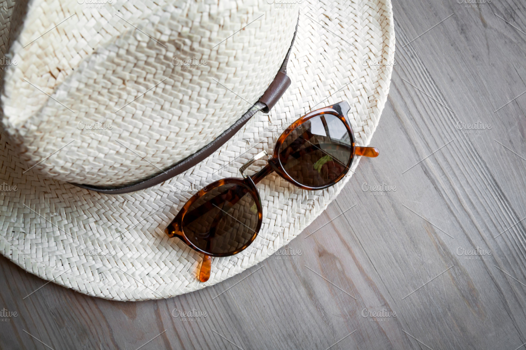 Straw hat with sunglasses containing hat, straw hat, and panama hat