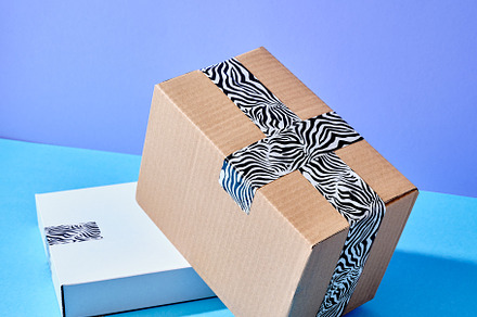 Stack of cardboard parcels packed with zebra patterned tape on c, a Transportation Photo by Asya Nurullina