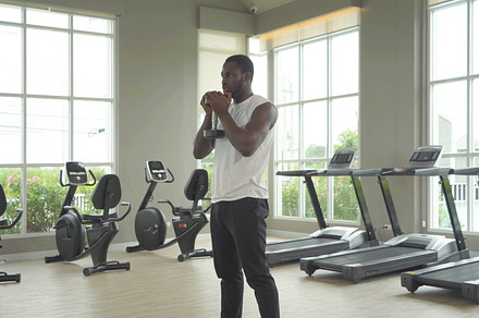 Portrait of strong black african american man using fitness equi, a Photo by Tampatra