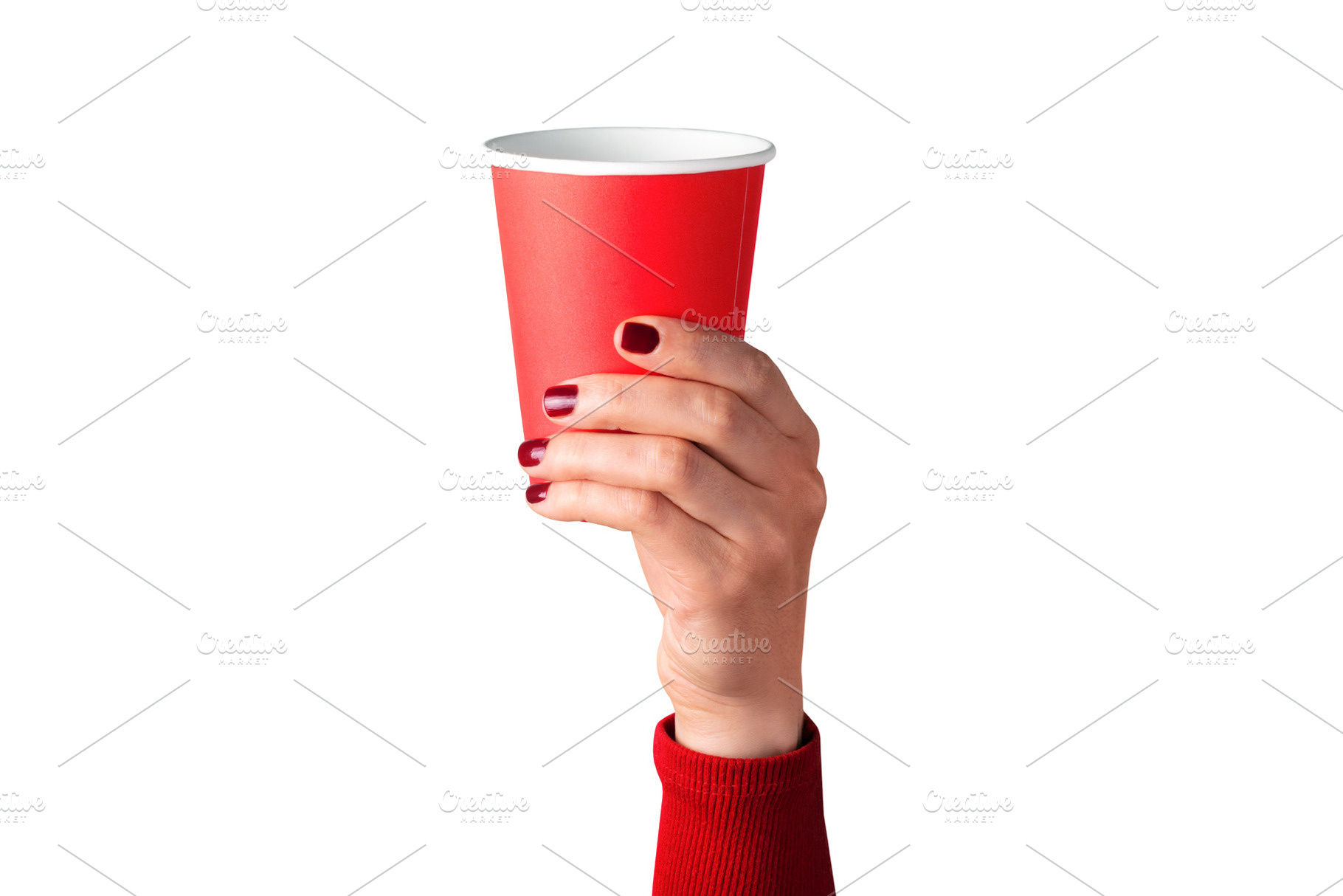 Female hand with red painted nails holding a red paper cup again, a Food & Drink Photo by Ales Munt