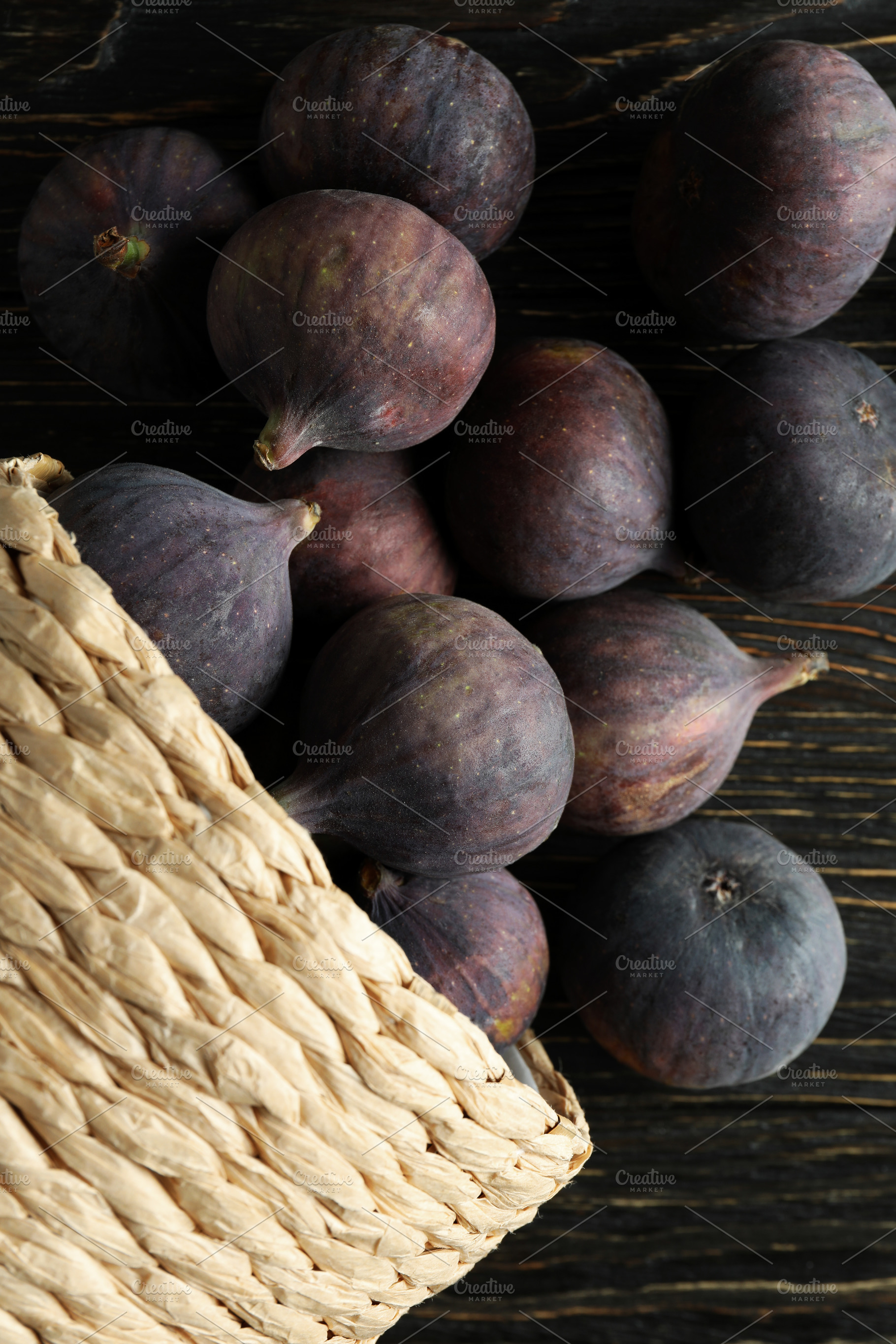 Wicker pot with fig on rustic wooden background, a Food & Drink Photo by AtlasStudio PRO