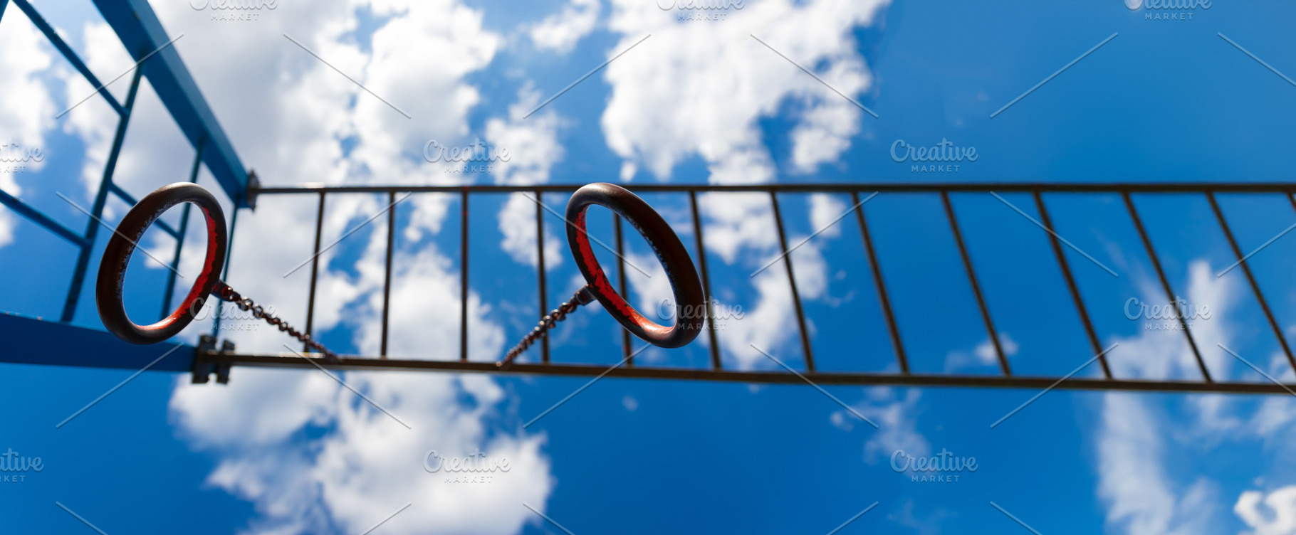 Close-up view of metal gymnastic rings and horizontal ladder bar, a Sports & Recreation Photo by Ales Munt