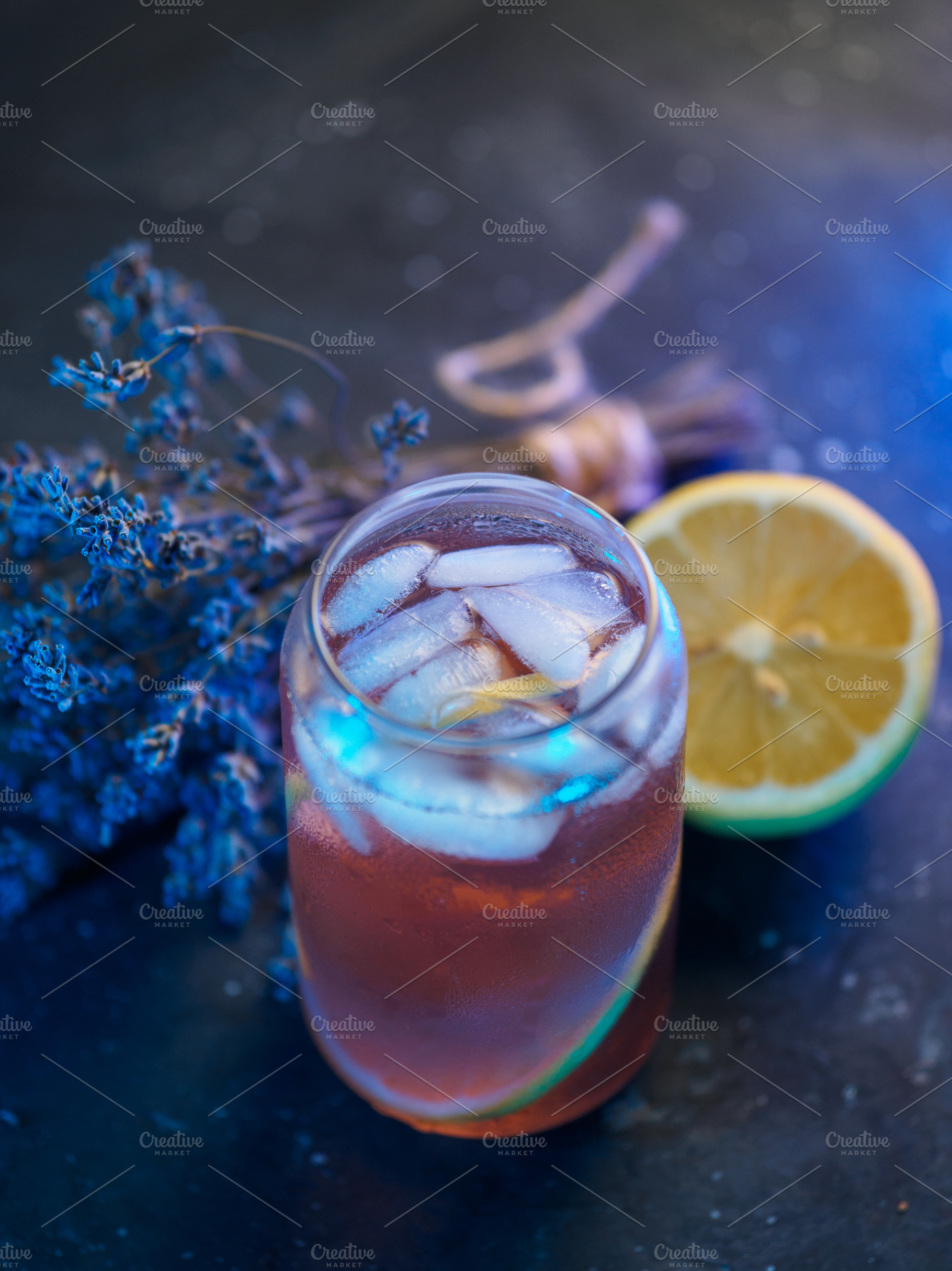 lavender drink with ice and lemon. stone background., a Food & Drink Photo by PavelKant