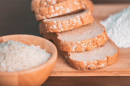 Slice bread rice and flour on wooden cutting board. Nutritious o, a Food & Drink Photo by Ministocker