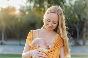 Mother holding her little baby in a, a Person Photo by Elizaveta Galitskaya