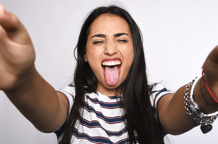 Young woman taking selfie stock photo containing happy and isolated, a Person Photo by Mego-studio