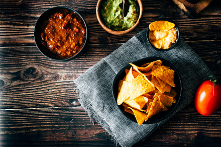 Mexican nachos with guacamole, cheddar cheese and chili.