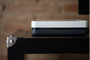 Modern Wi-Fi router sitting on a, a Technology Photo by volodymyrshtun13795