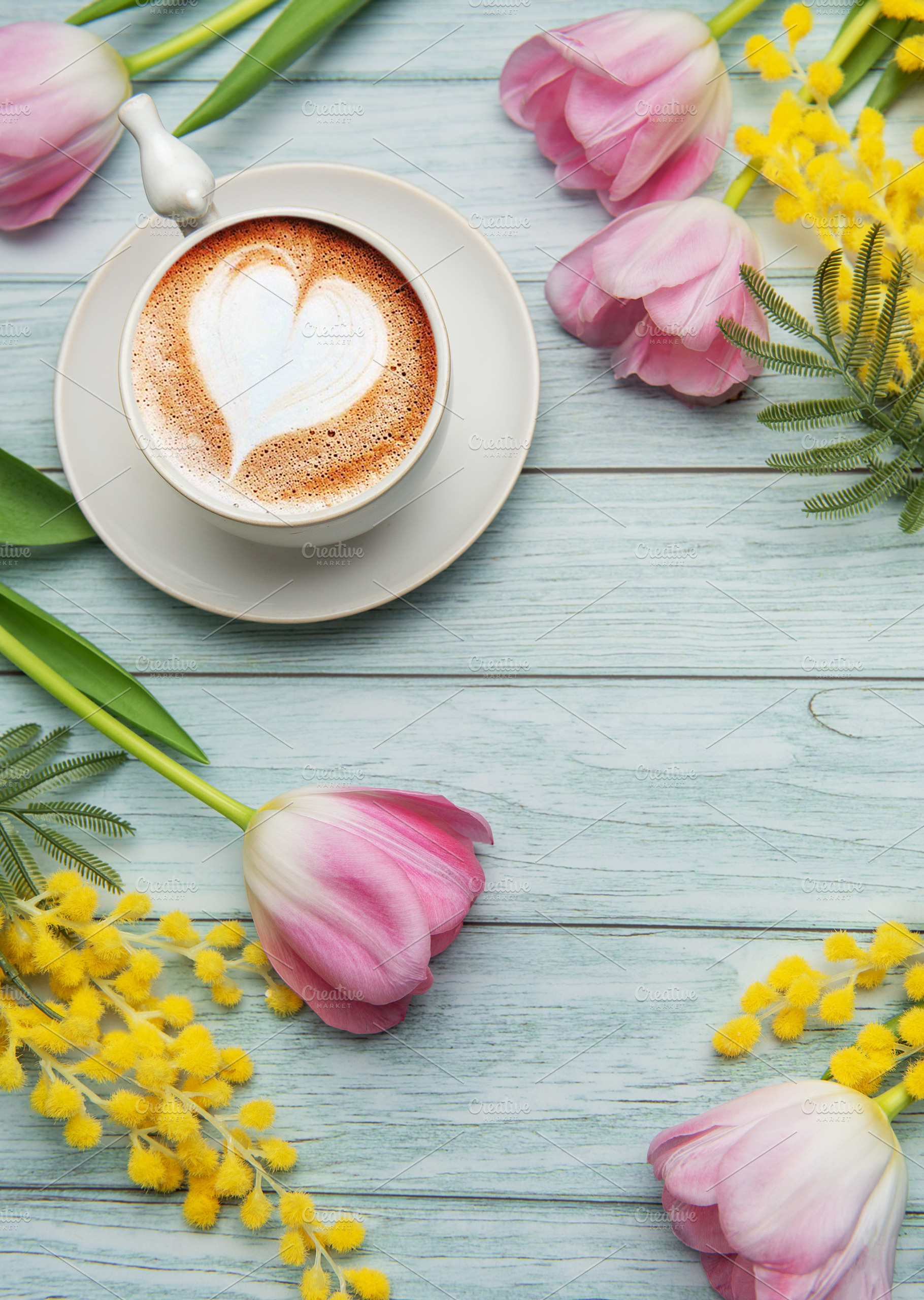 Cappuccino with heart shaped foam near pink tulips and mimosa fl, a Holiday Photo by Olena Rudo