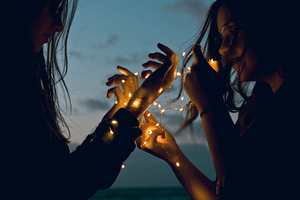 Two girls holding lights