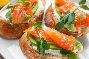Smoked salmon toast with avocado, cream cheese, and microgreens, a Food & Drink Photo by Olena Rudo