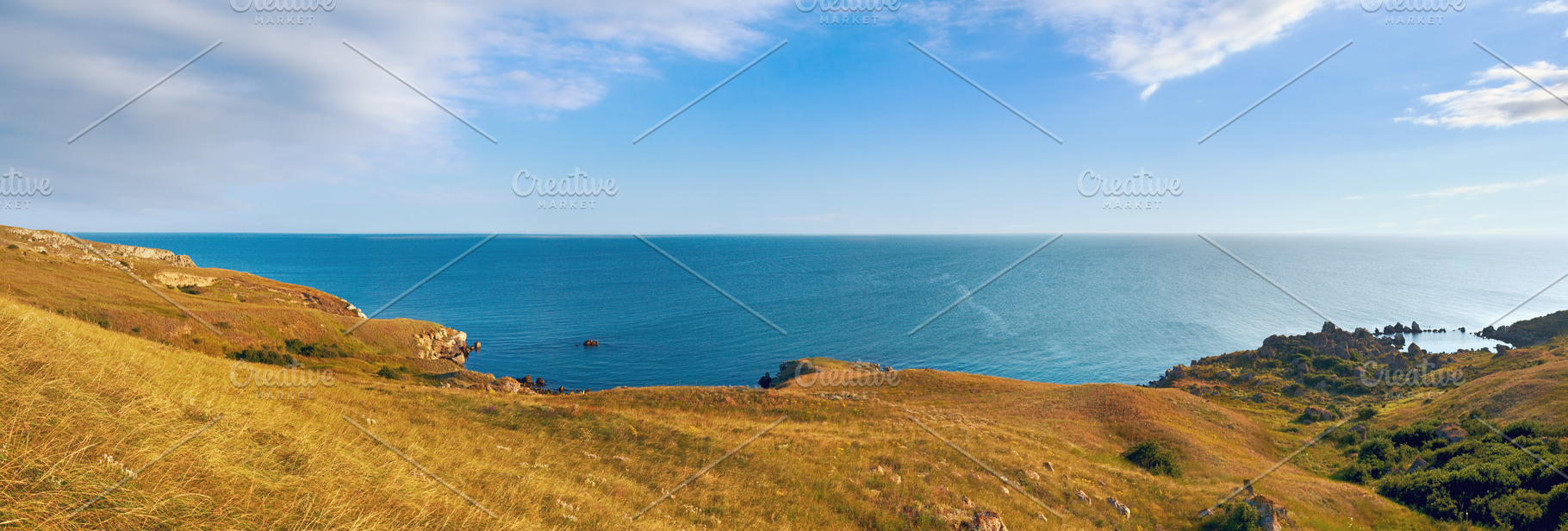 Sea beach with small rocky lagoon and coastal grass., a Nature Photo by YuriyB