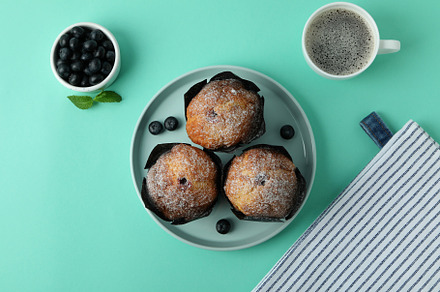 Concept of delicious food with chocolate muffins on mint backgro, a Food & Drink Photo by AtlasStudio