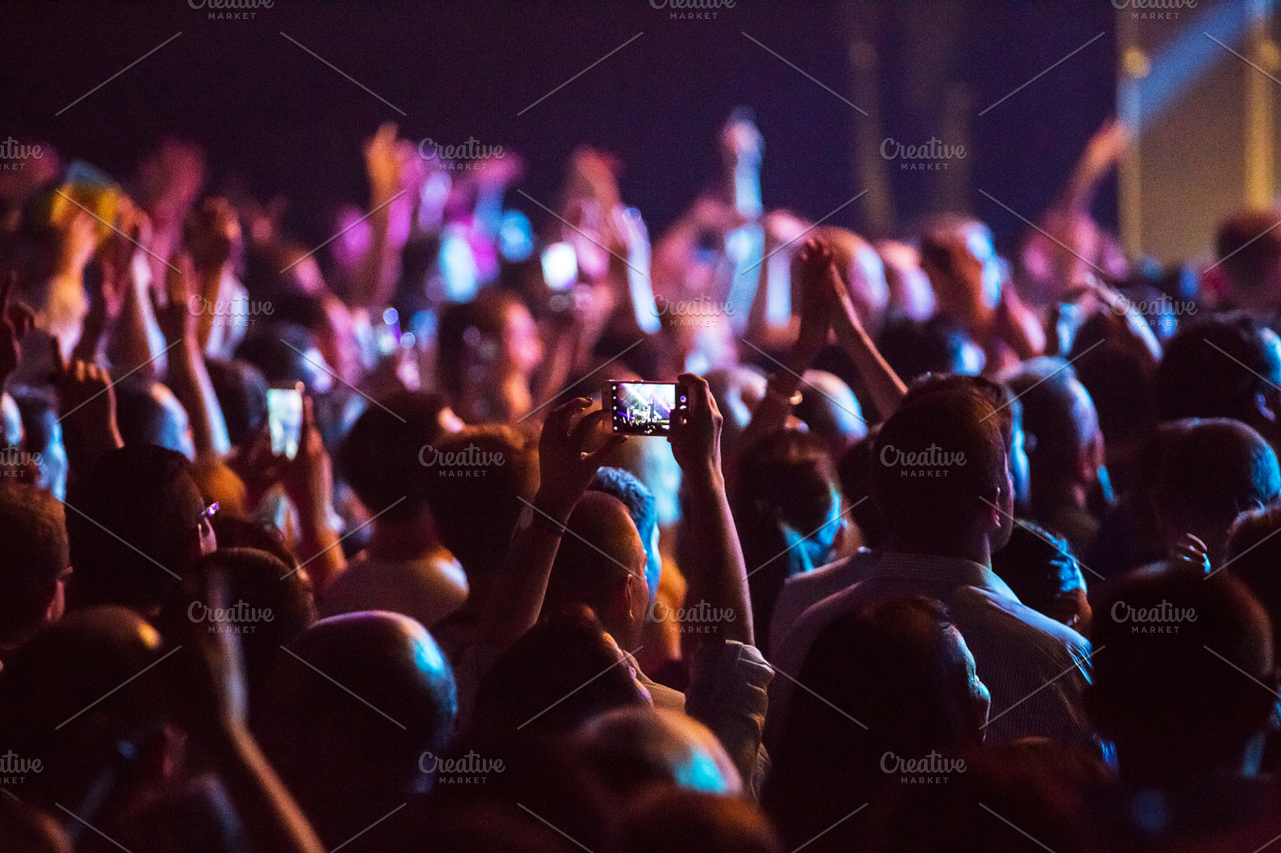 Crowd at concert and blurred stage lights  containing crowd, people, and event, a Person Photo by suprunvitaly