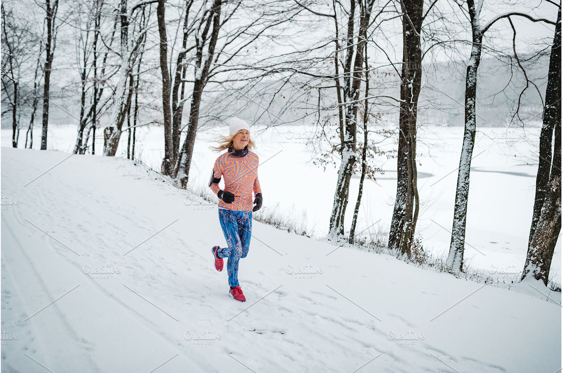 Active elderly woman jogging in cold, a Sports & Recreation Photo by HalfPoint