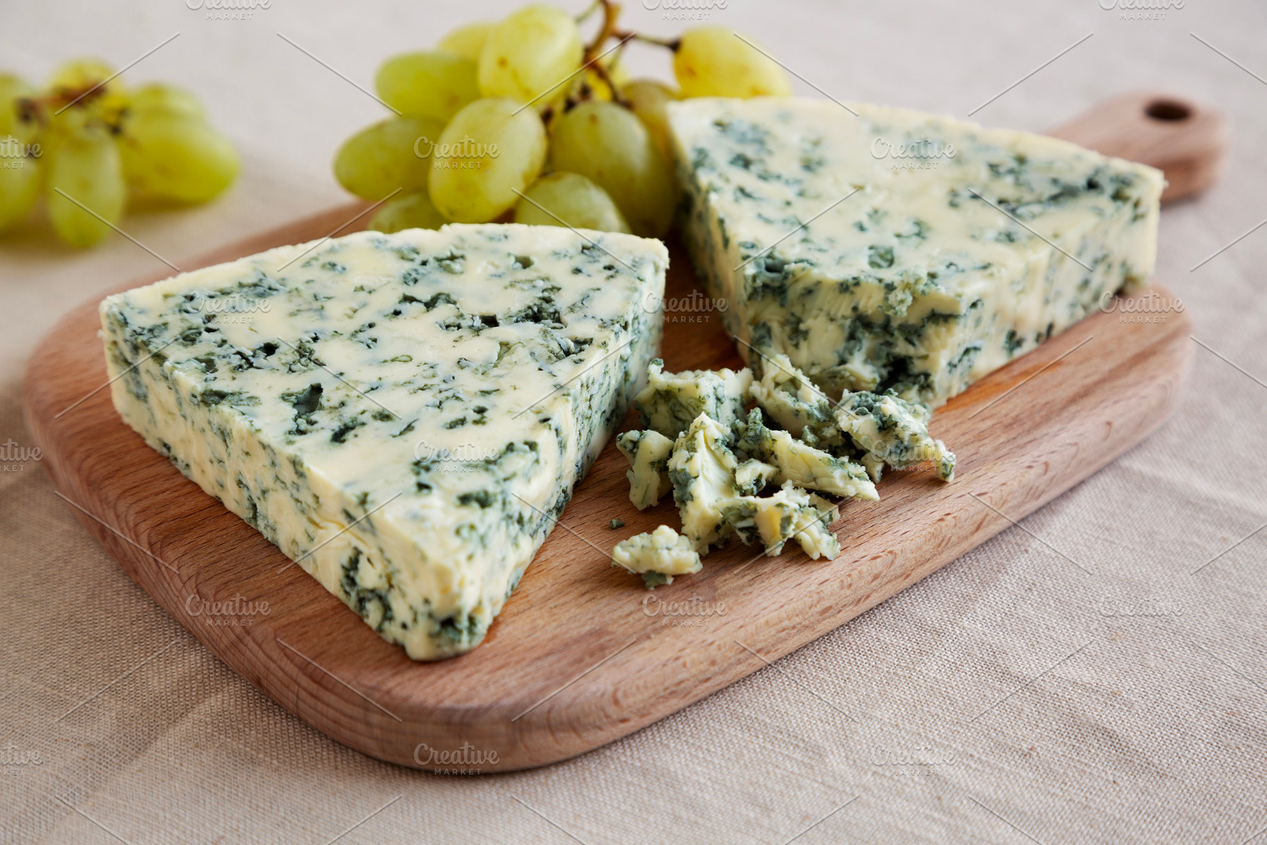 Delicious Cheese Danablu on a wooden board, side view., a Food & Drink Photo by LiudmylaChuhunova