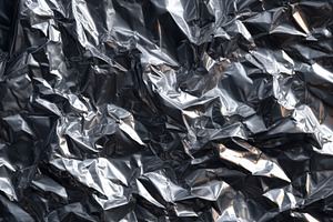 Crumpled metallic foil texture, a Background Photo by AlyaAnd