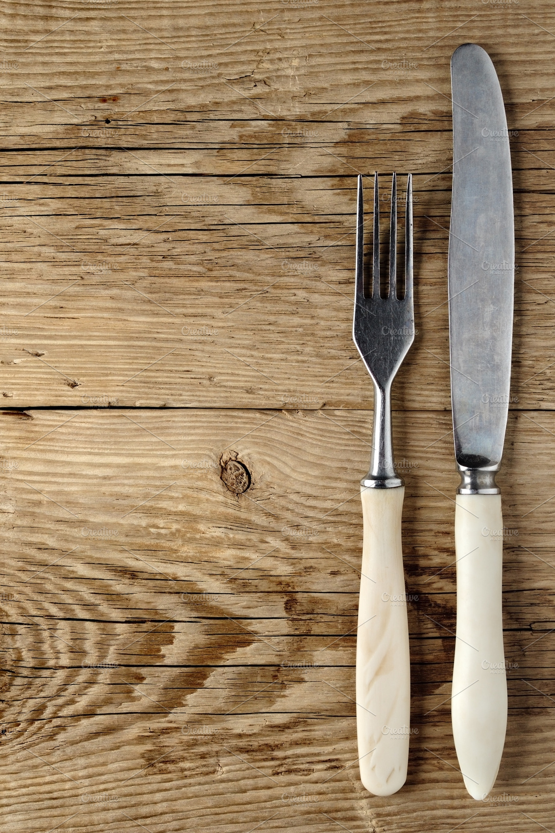 Old fork and knife featuring fork, old, and scratched