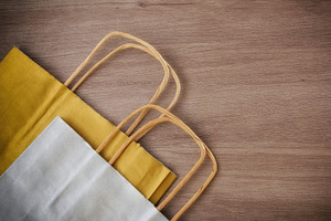 Detail of two paper shopping bag on wooden table, a Holiday Photo by Davizro's Market