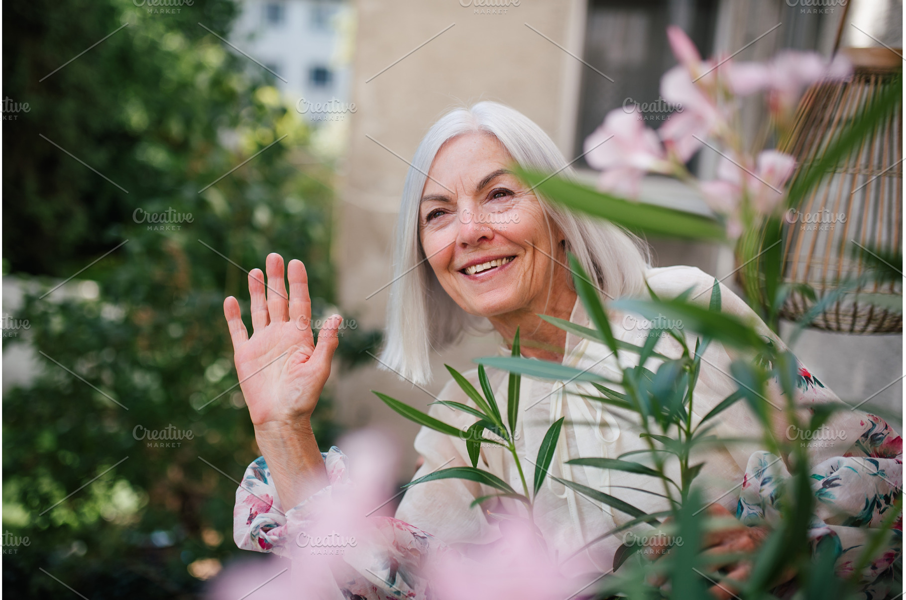 Beautiful senior neighbor waving at, a Person Photo by HalfPoint
