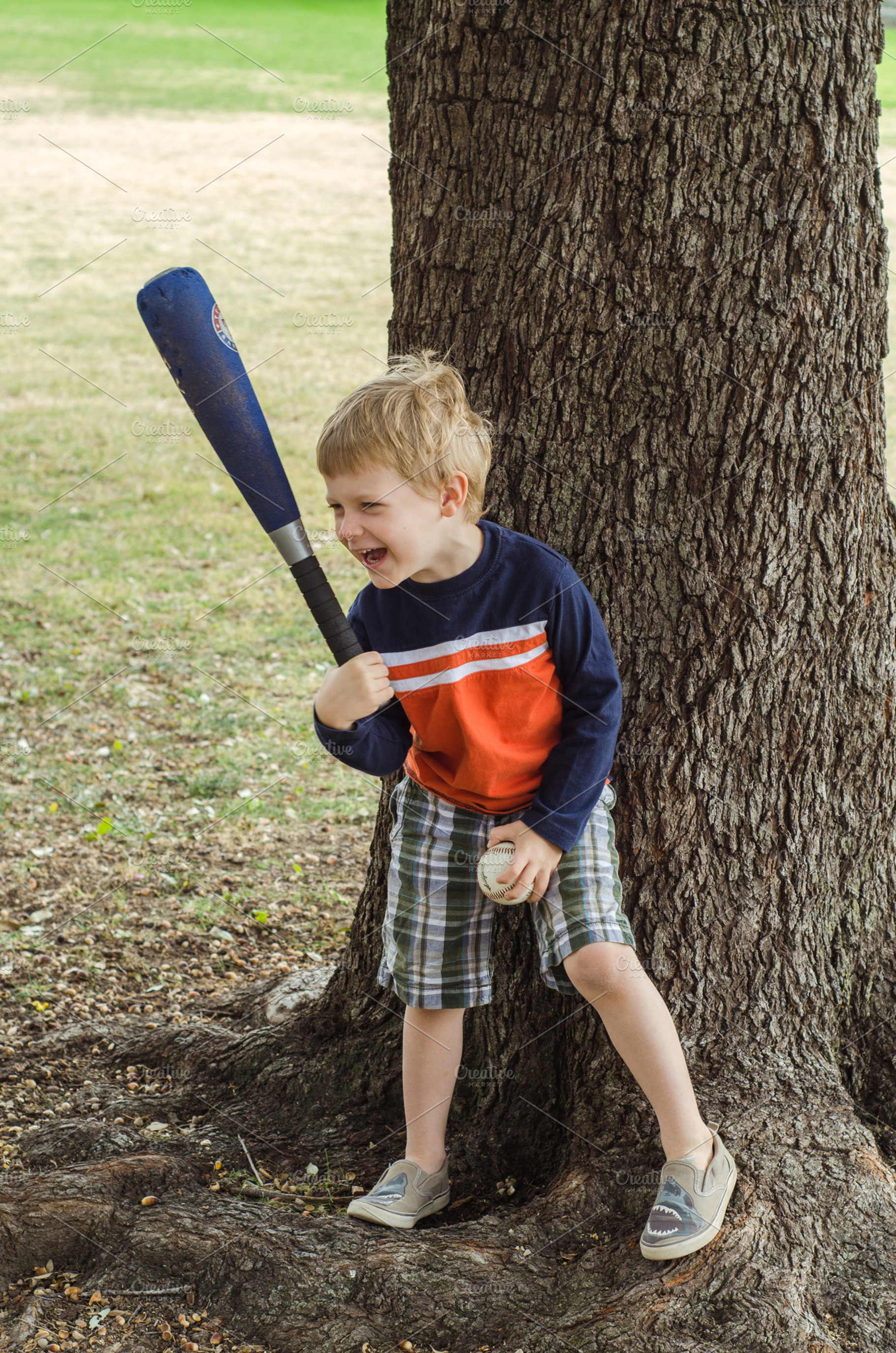 Boy with Bat and Ball Laughing