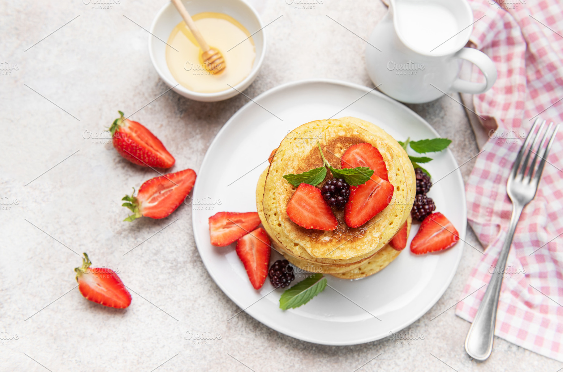 Stacked pancakes with fresh berries and honey, a Food & Drink Photo by Olena Rudo