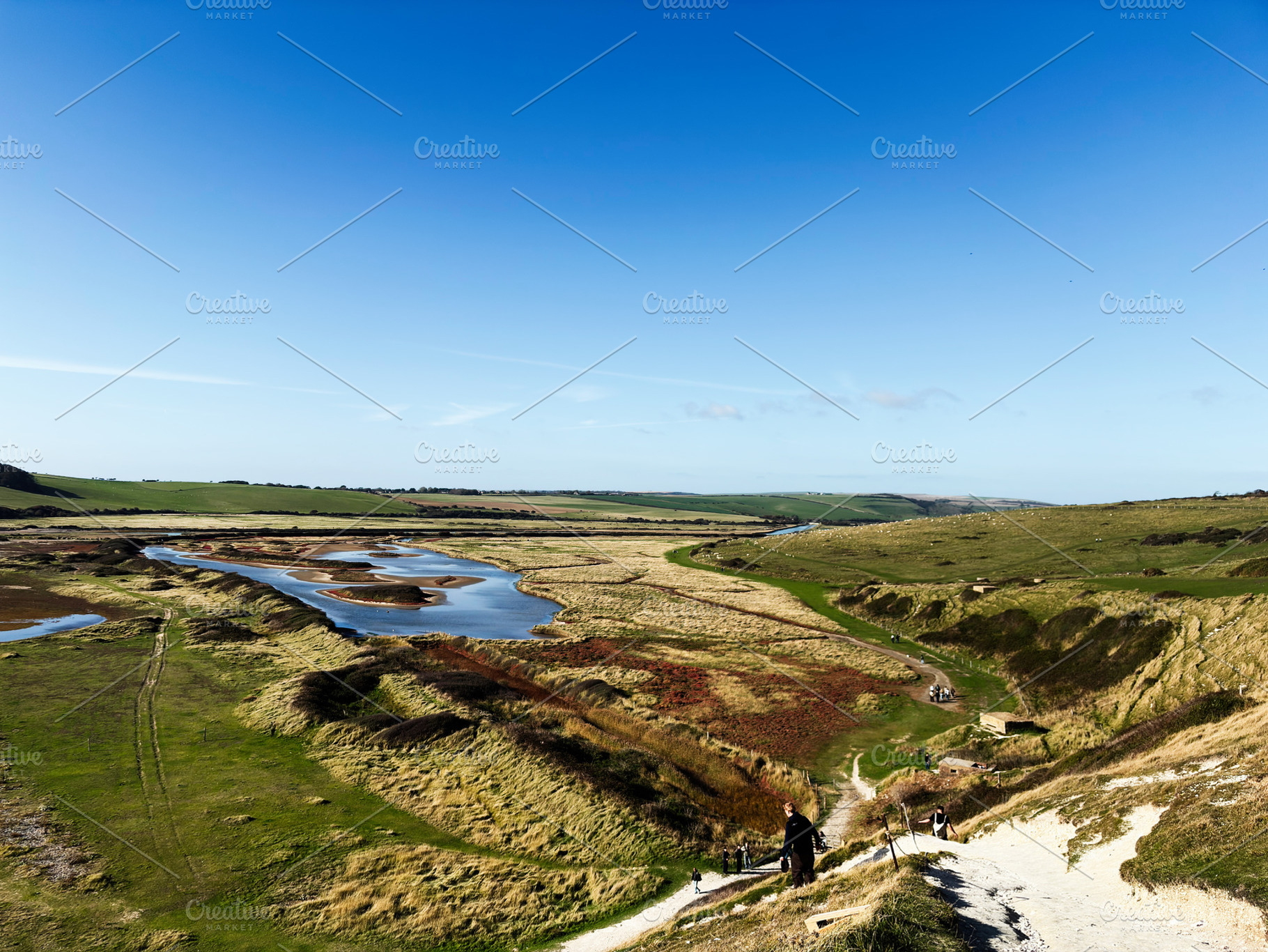 Hikers descend coastal path on Seven Sisters Cliffs in East Sussex UK, scenic l, a Nature Photo by AS photostudio