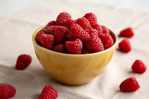 Organic Raw Red Raspberries in a Bowl, side view. Close-up., a Food & Drink Photo by LiudmylaChuhunova