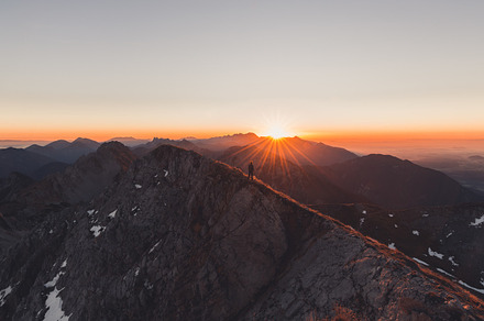 Male hiker at mountain at sunrise containing mountain, top, and adventure, a Nature Photo by Dreamy Pixel