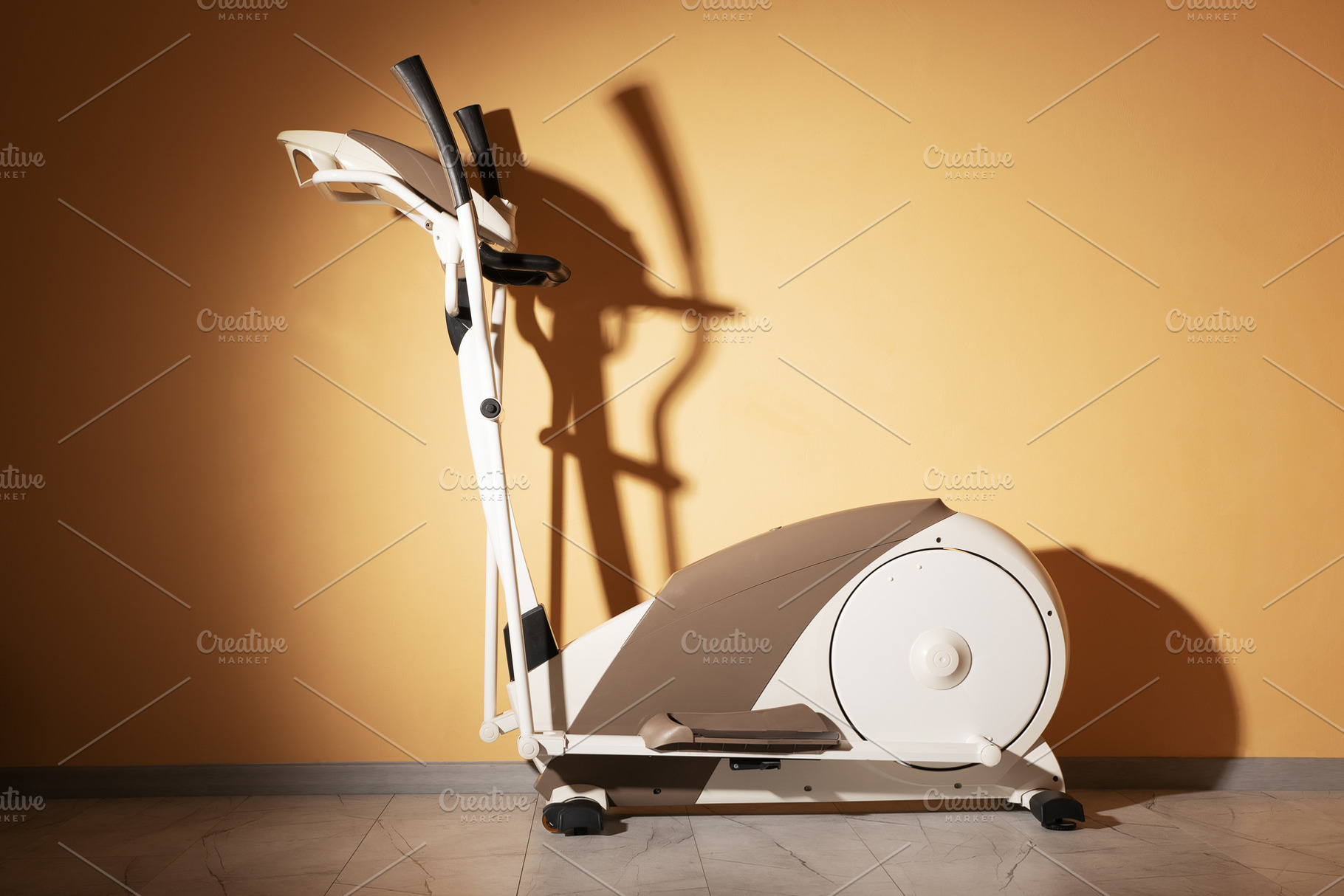 Modern elliptical fitness machine in sunlight, standing on a mar, a Sports & Recreation Photo by Ales Munt