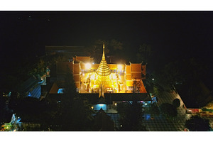 Golden pagoda shining at night in a, an Architecture Photo by Goinyk