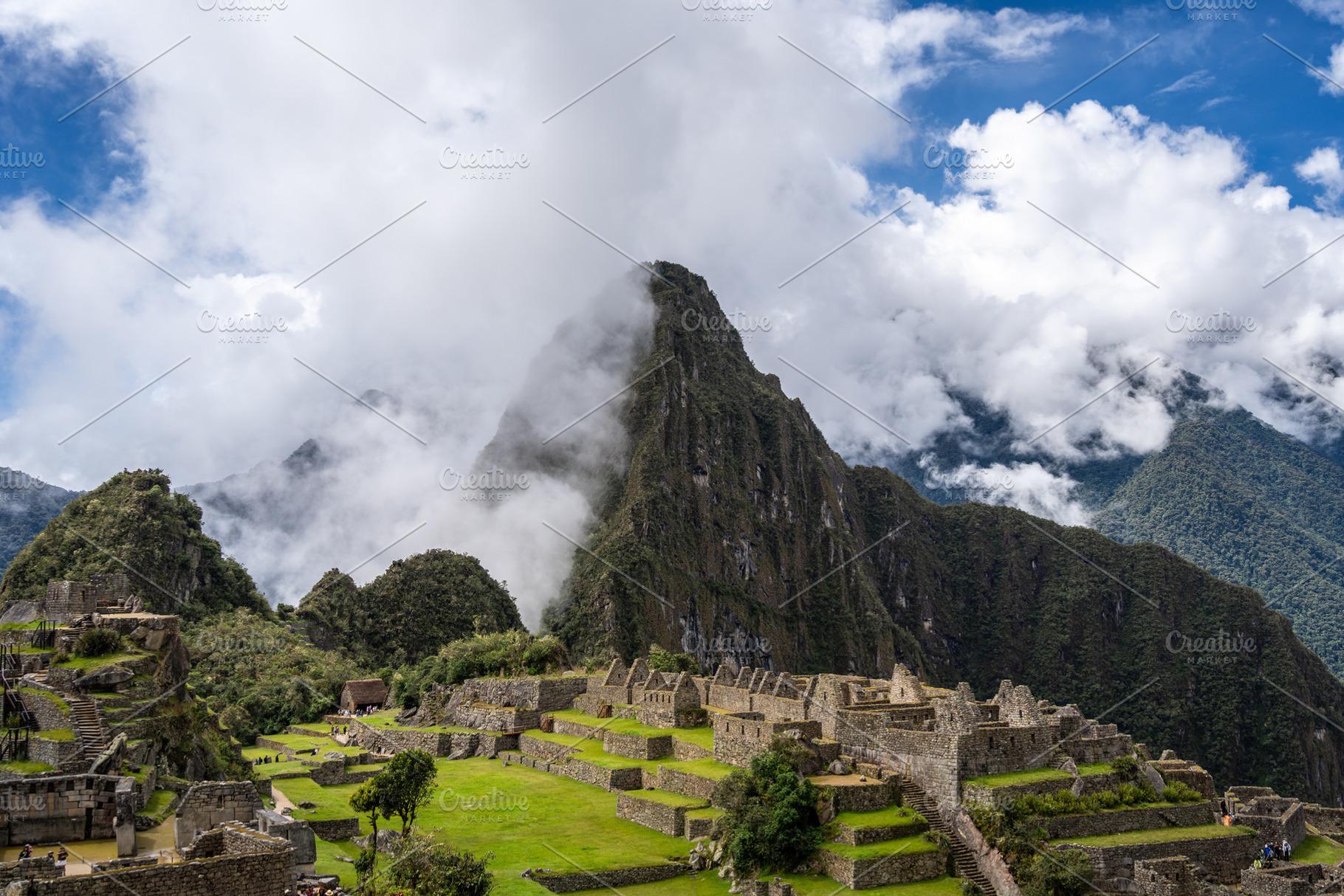 Panoramic view of Machu Picchu ruins surrounded by misty mountai, a Photo by GoodGoods