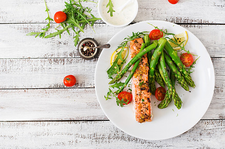 Salmon garnished with asparagus containing salmon, asparagus, and dinner