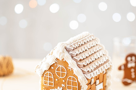 Christmas gingerbread house containing house, gingerbread, and background