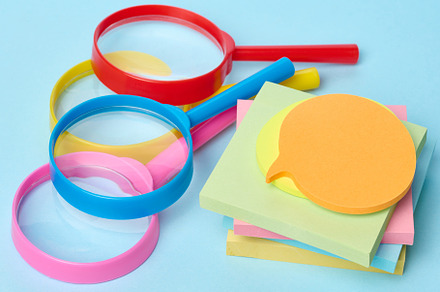 Multicolored plastic magnifying glasses on a blue background and, a Business Photo by ndanko