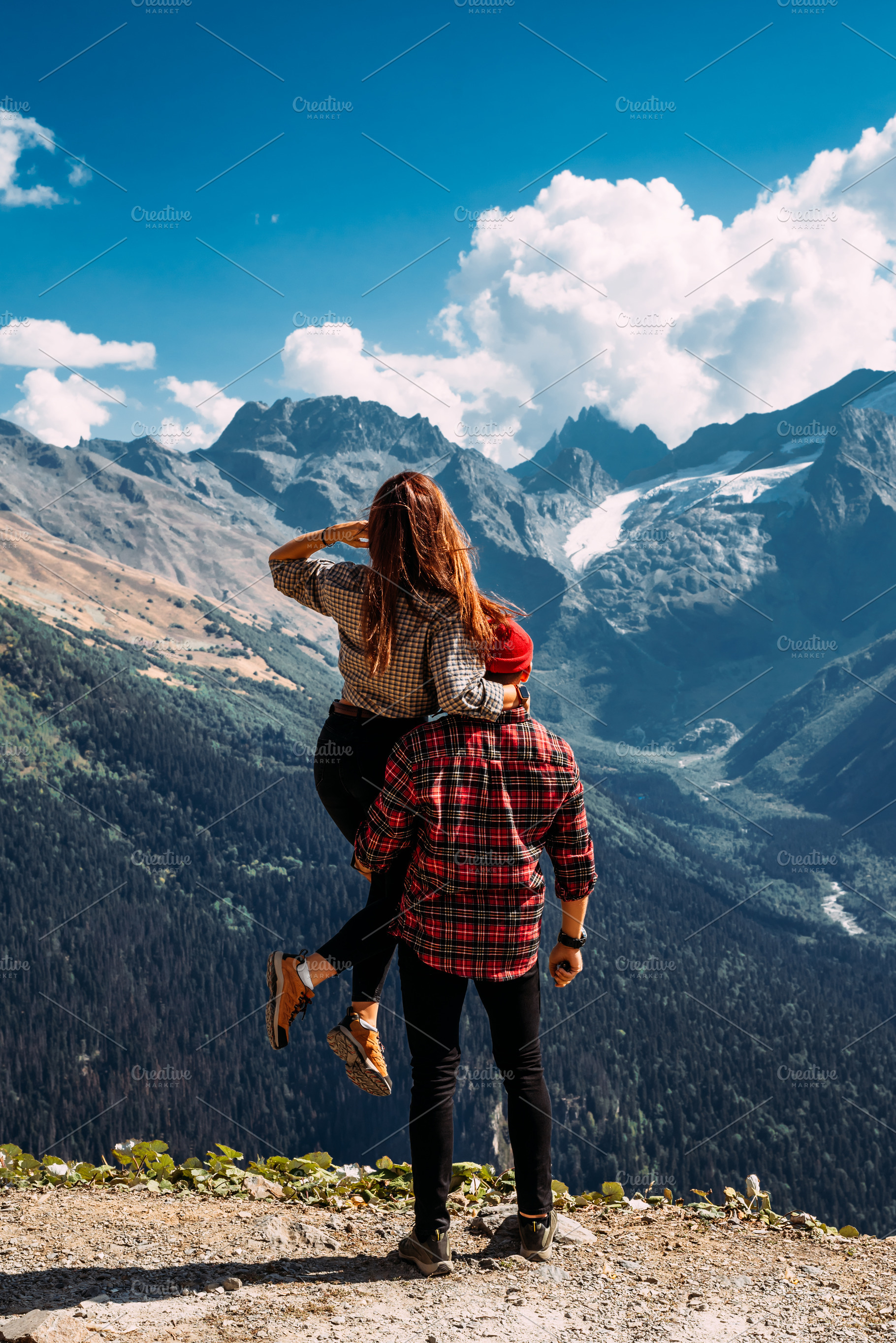 A man and a woman in the mountains, a Person Photo by SOTNIKOV_MISHA