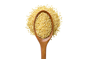 Millet in a wooden spoon on a white, a Food & Drink Photo by innakreativ