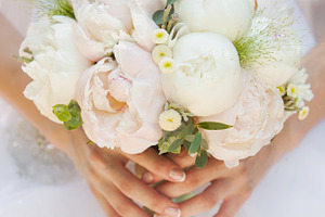 Bride with beautiful wedding bouquet featuring bouquet, bride, and floral