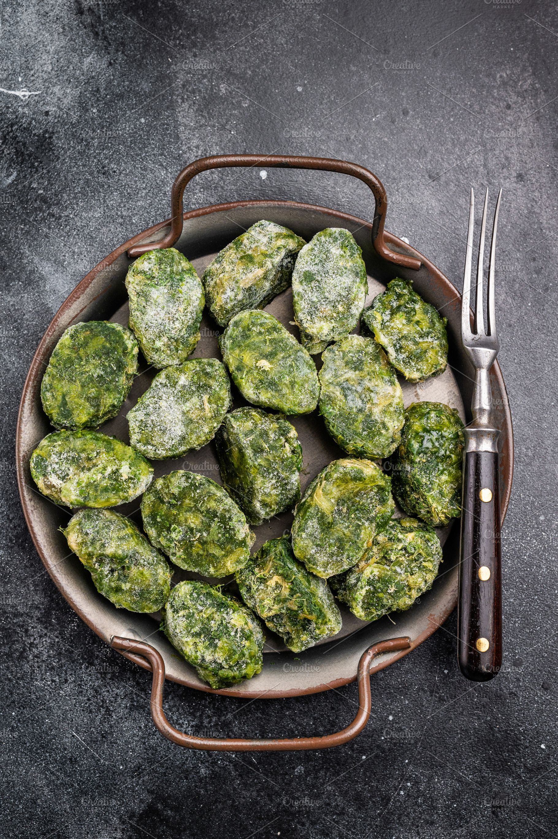 Raw, frozen green vegetable (spinach) portions in a metal servin, a Food & Drink Photo by composter-box@mail.ru