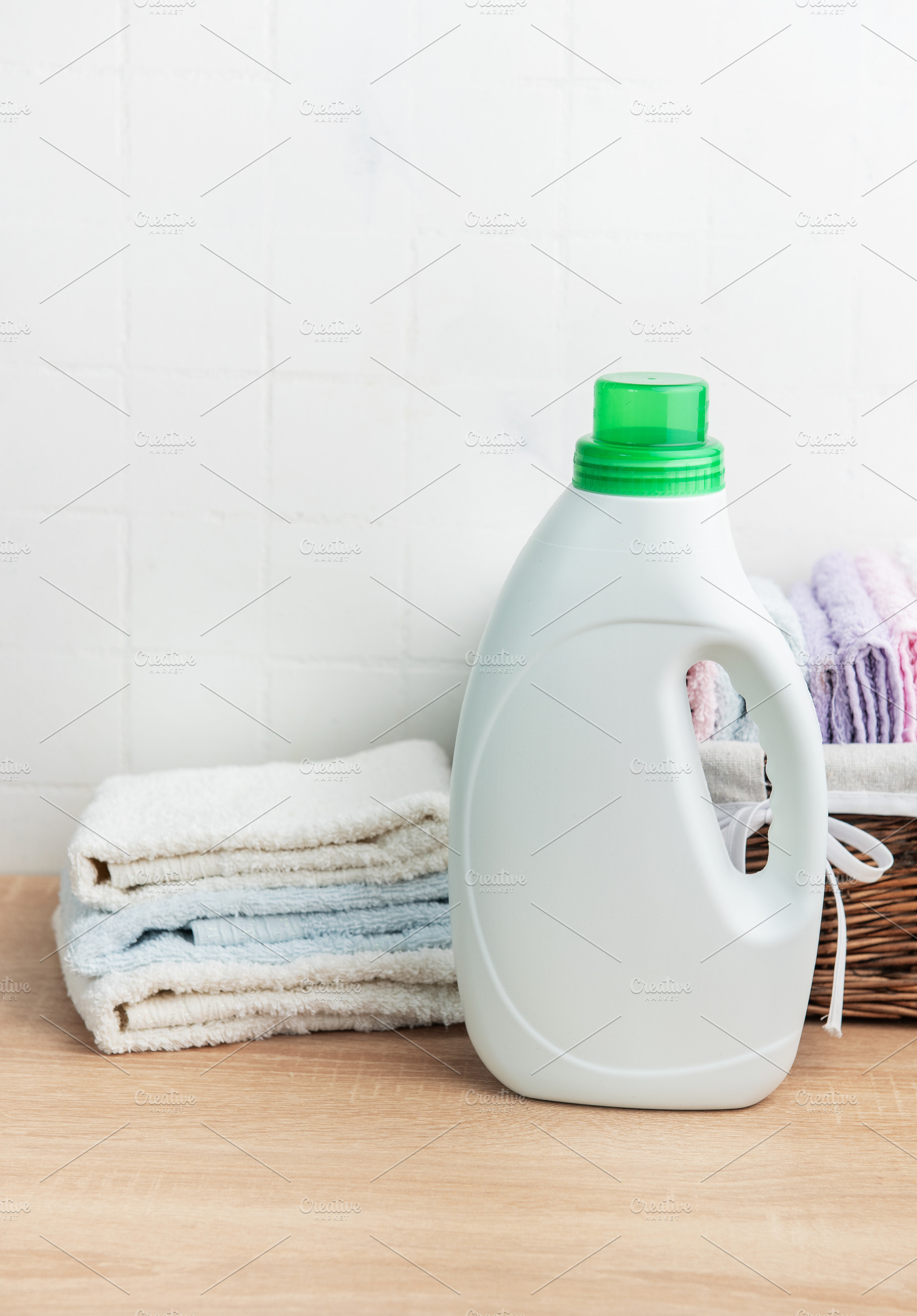 Detergent bottle, laundry and clean fresh towels, an Industrial Photo by Olena Rudo