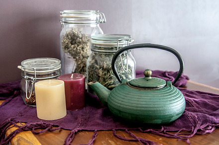 Teapot with candles and tea