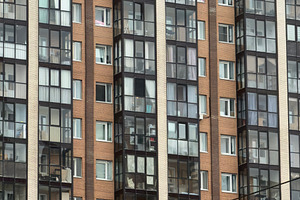A close-up view of a modern residential building facade, featuring a mix of gla, an Industrial Photo by Textures & Backgrounds