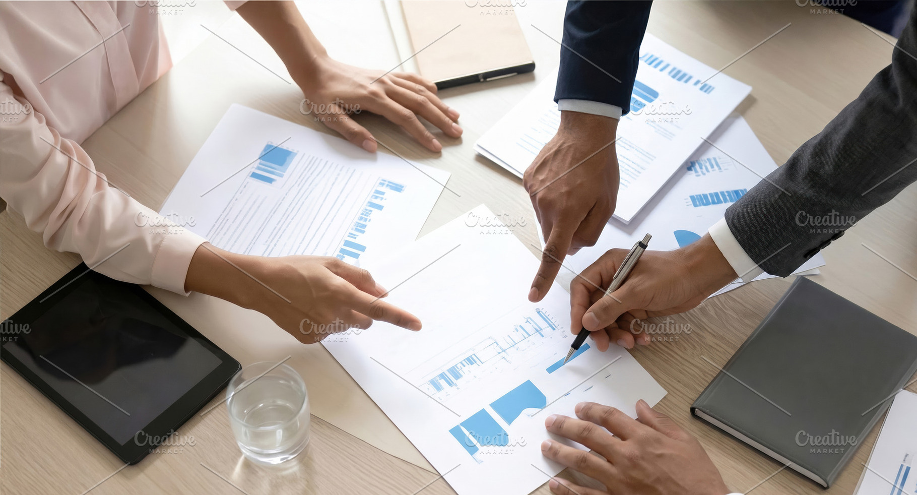 Business Team Reviewing Financial Charts Together, a Business Photo by Davizro's Market
