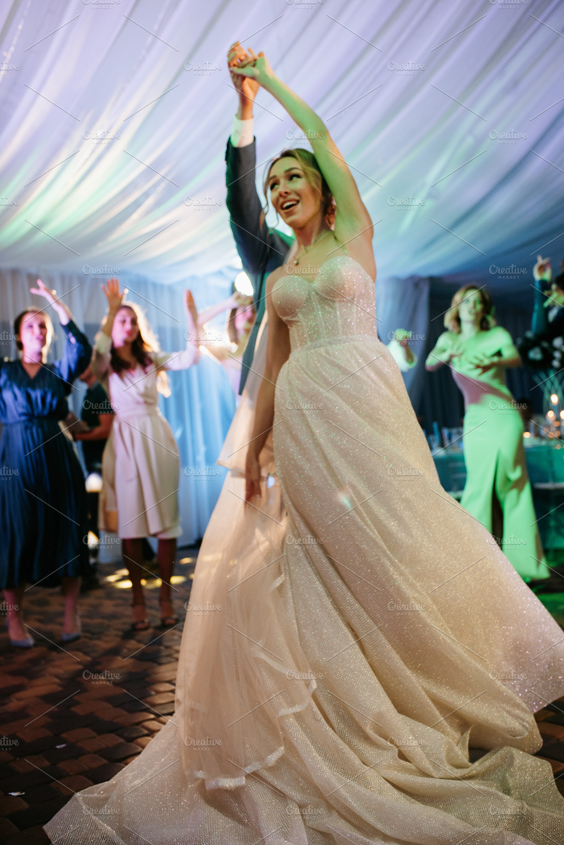 bride with bridesmaids dancing on dance floor in wedding, a Person Photo by Weddings, People, Travel