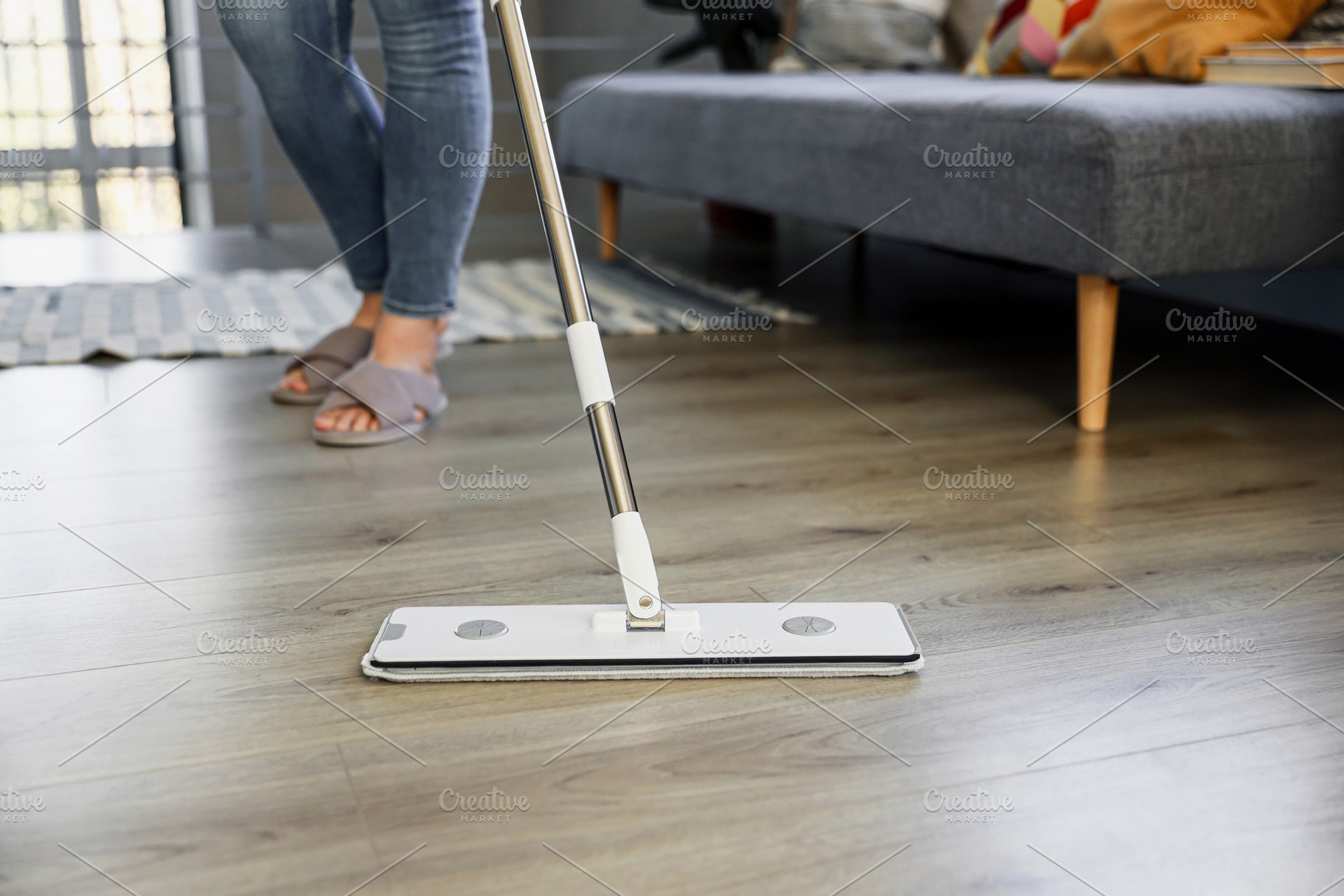 Woman mopping, wiping floor in modern home setting, a Person Photo by Lenor4ik