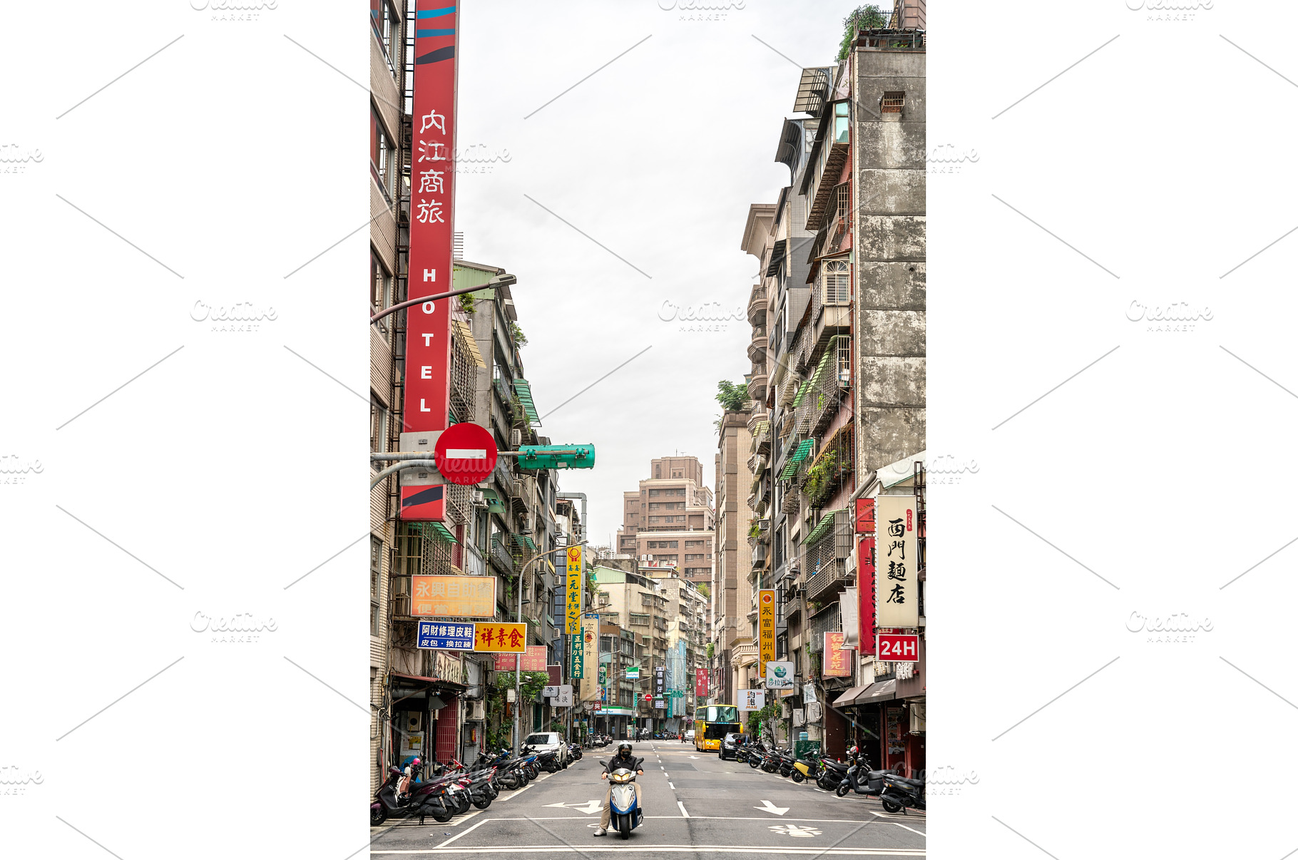 Scooter navigating a sign-lined, an Architecture Photo by Leonid Andronov